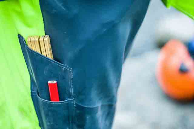 side pocket and knee pads on construction rain gear bibs
