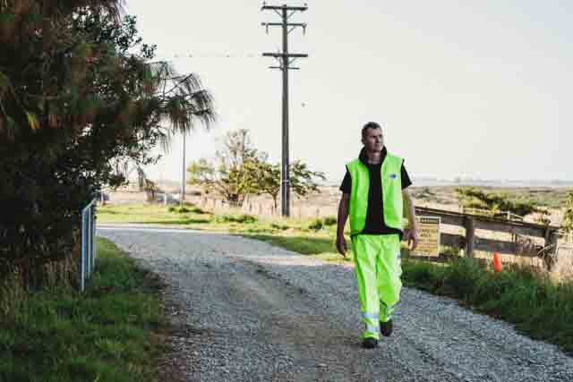 Roadworker in New Zealand wearing industrial wet weather gear workwear