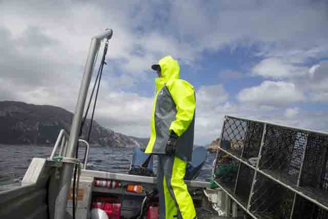 Fisherman wearing commercial rain gear on a boat