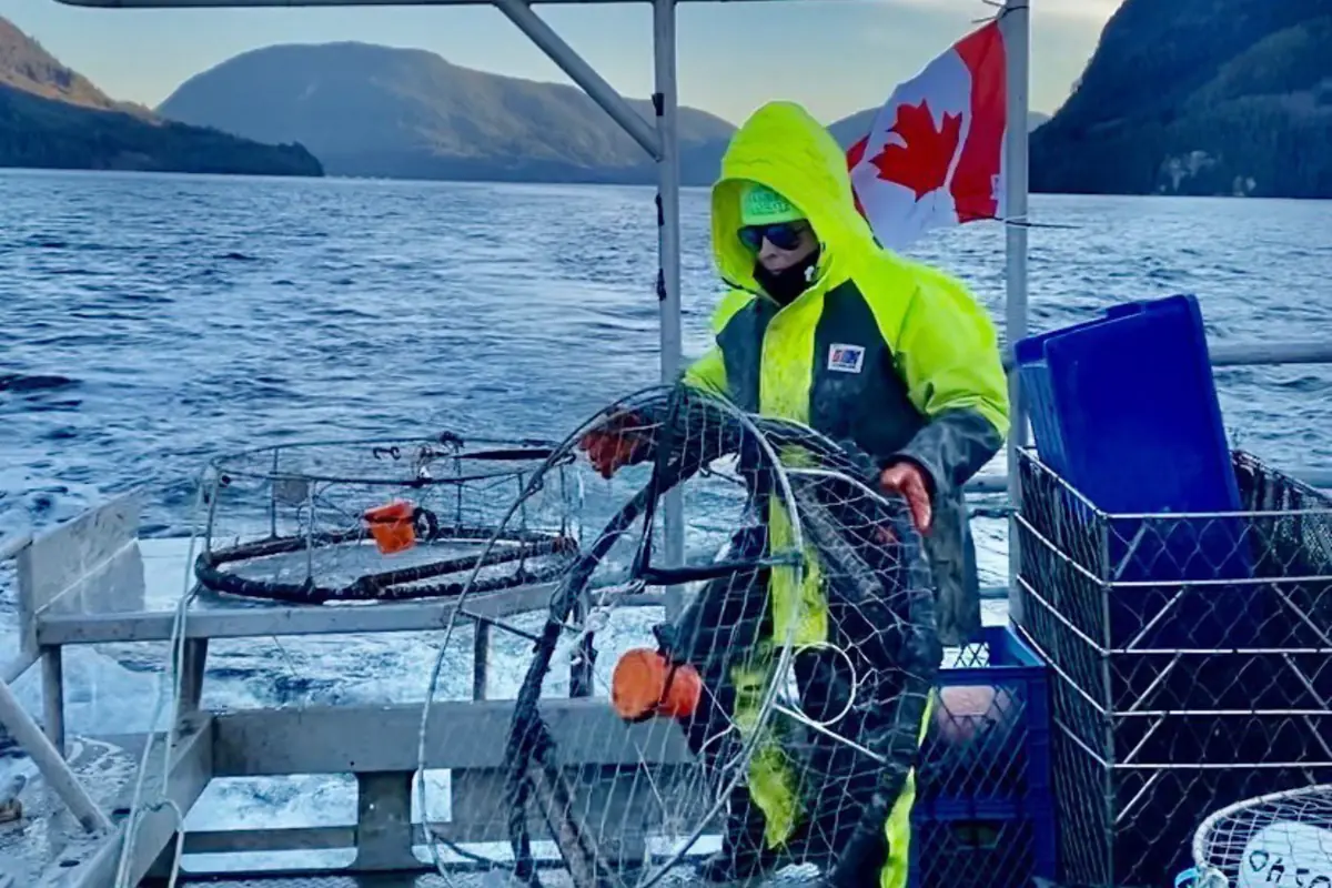 Commercial fisherman wearing Stormline waterproof rain gear while handling fishing traps on a boat in British Columbia.